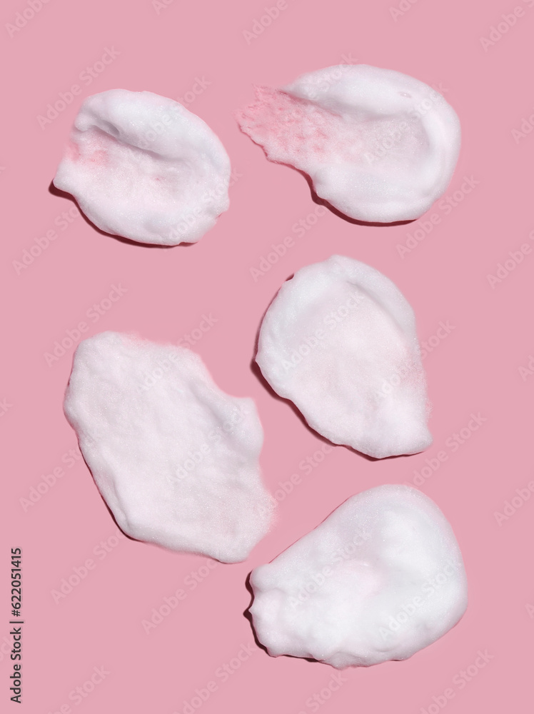 Texture of foam or mousse strokes on a pink background. Soap, shower gel, foam shampoo. Skin care. View from above. Texture of foam or mousse strokes on a pink background. Soap, shower gel, foam shampoo. Skin care. View from above.