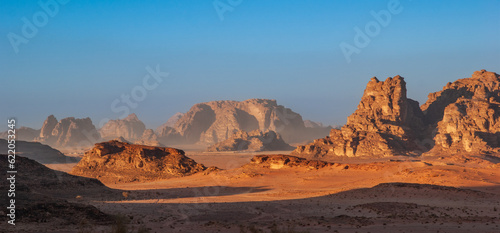 Magic mountain landscapes of Wadi Rum Desert  Jordan. Mountains in lifeless desert resemble Martian craters.  Sand is beautiful pink color and and red rocks. There is place for text.