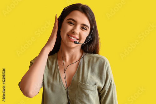 Female technical support agent on yellow background