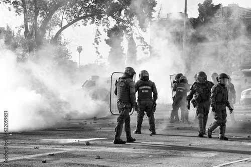 Santiago, Chile - October 18, 2022 - police surrounded by tear gas in a social demonstration