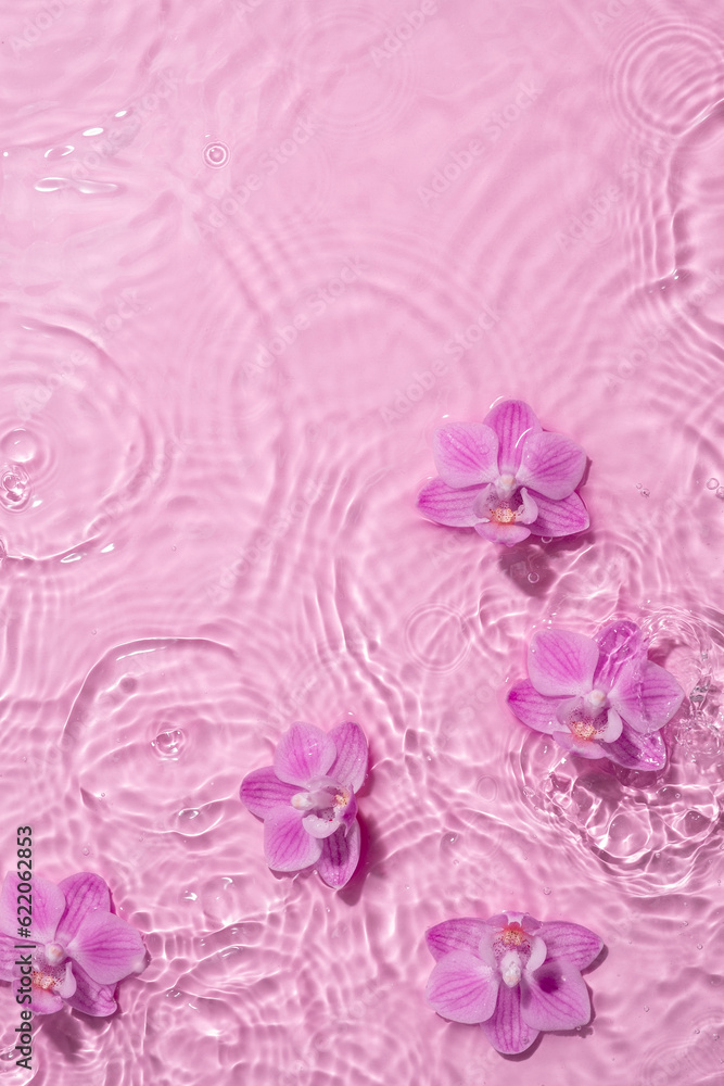 Orchid flowers are floating, stains from a drop on the water