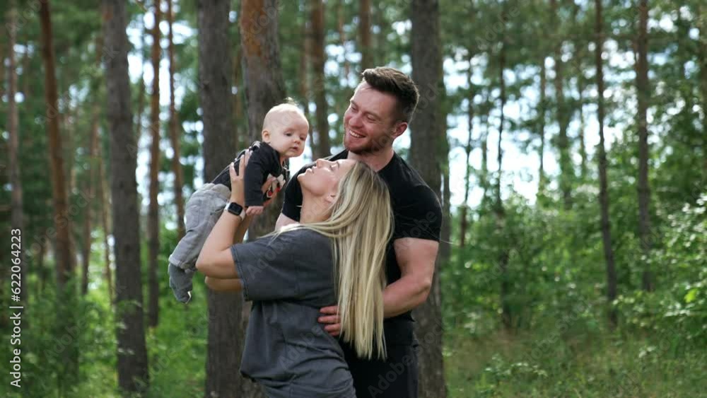 Mom and dad with their newborn son spending time in the forest. Happy family on vacation. Mom and dad with their newborn son spending time in the forest. Happy family on vacation.