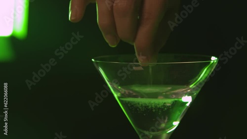 Putting Drugs in a Drink at the bar photo