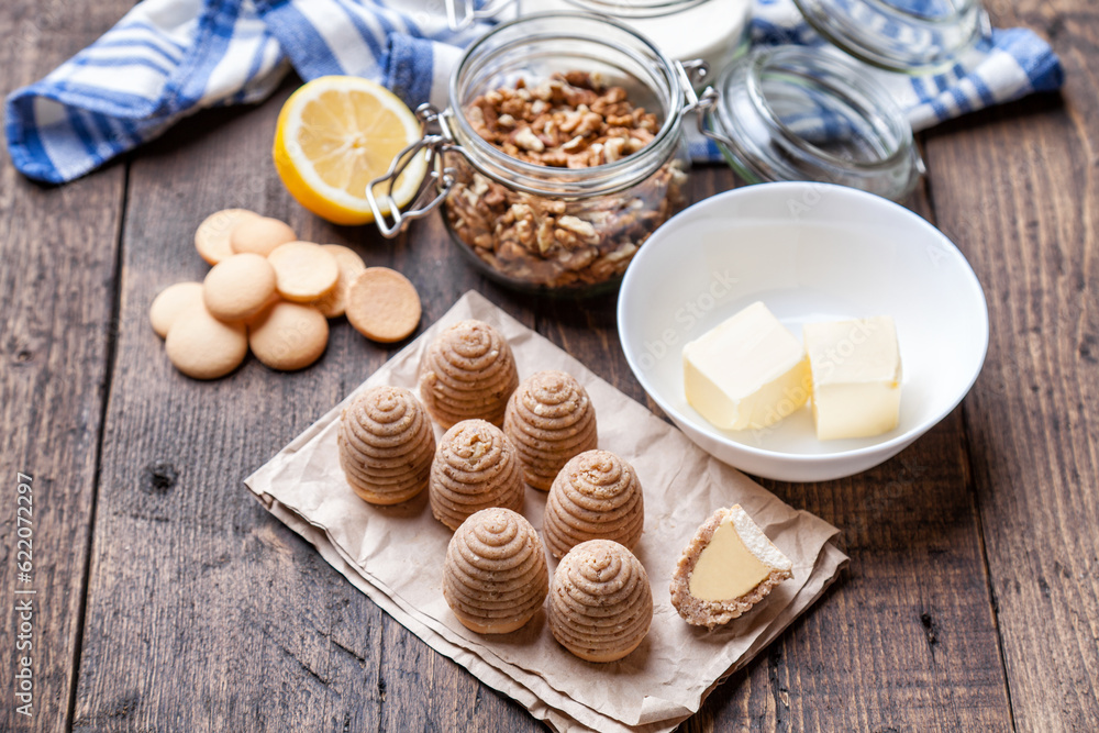 Traditional bee nest cake and ingredients on wooden background Traditional bee nest cake and ingredients on wooden background