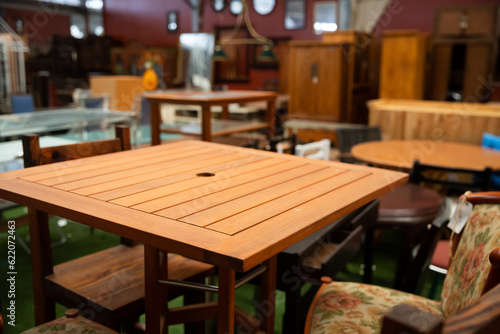Wide selection of dining and coffee tables in modern furniture shop..