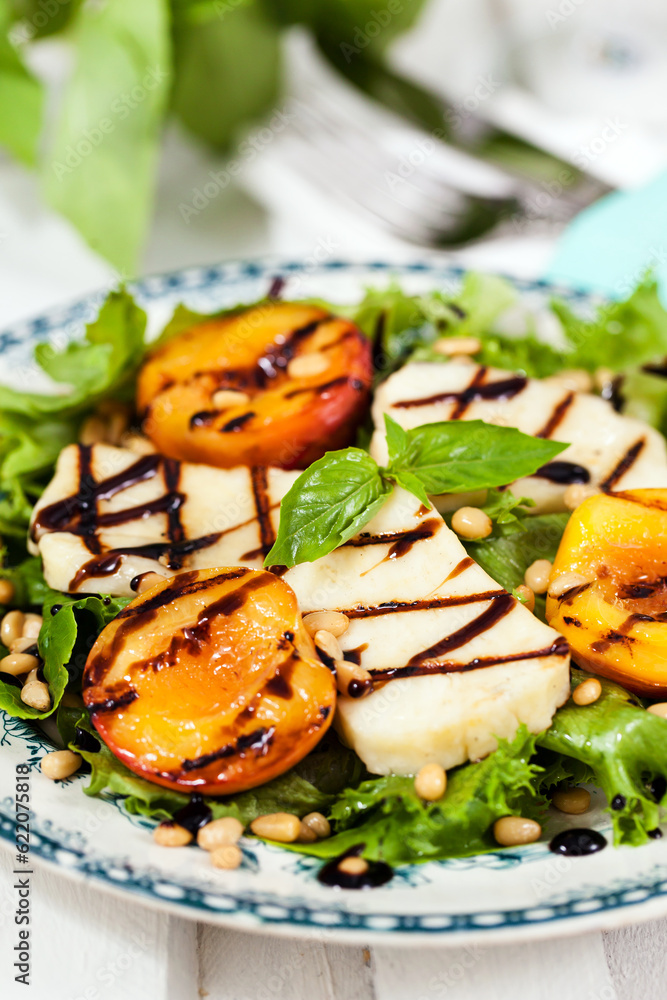 Fresh green salad with grilled halloumi cheese and peaches Fresh green salad with grilled halloumi cheese and peaches