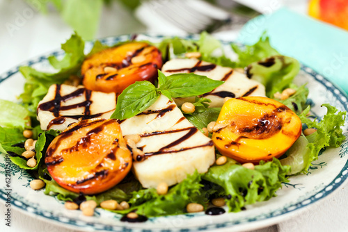 Fresh green salad with grilled halloumi cheese and peaches