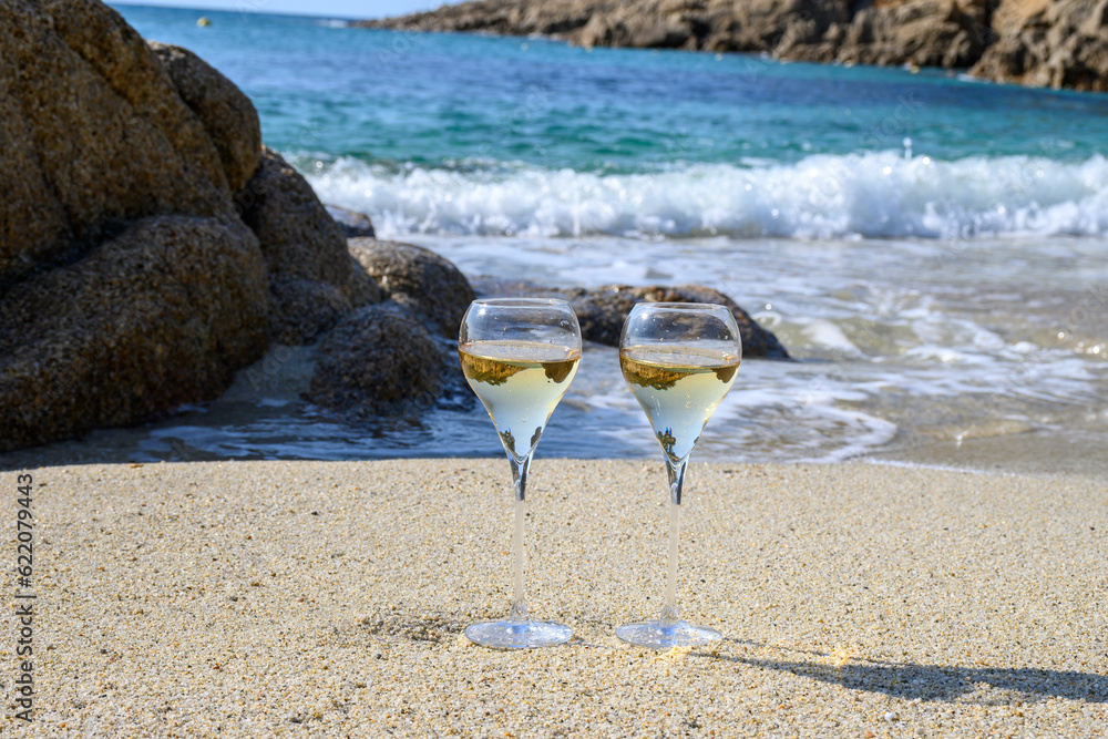 Summer time in Provence, two glasses of cold champagne cremant sparkling wine on sandy beach near Saint-Tropez in sunny day, Var department, France Summer time in Provence, two glasses of cold champagne cremant sparkling wine on sandy beach near Saint-Tropez in sunny day, Var department, France