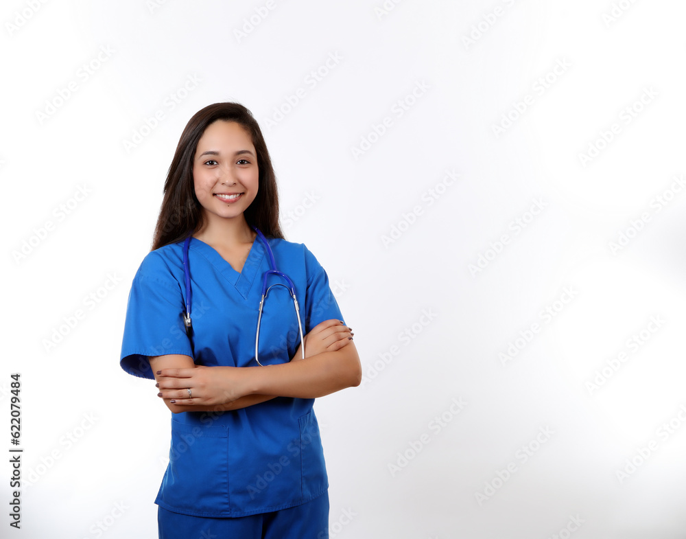 A friendly hispanic nurse wearing blue scubs and smiling at the camera. A friendly hispanic nurse wearing blue scubs and smiling at the camera.