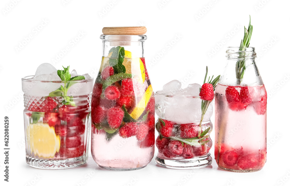 Glasses and bottles of fresh raspberry lemonade on white background Glasses and bottles of fresh raspberry lemonade on white background