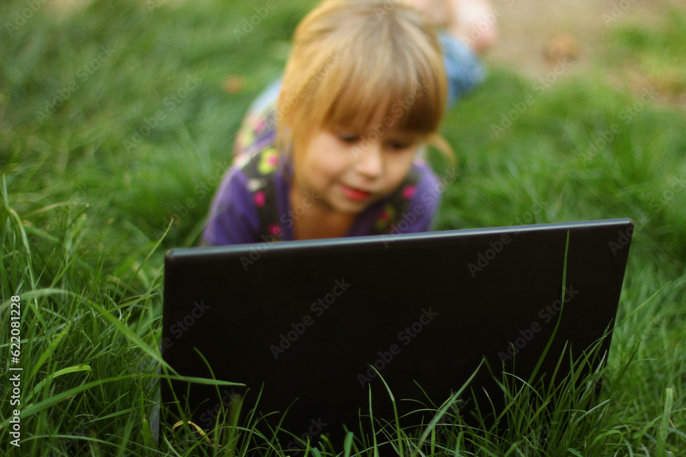 very nice and beautiful little girl with a laptop very nice and beautiful little girl with a laptop