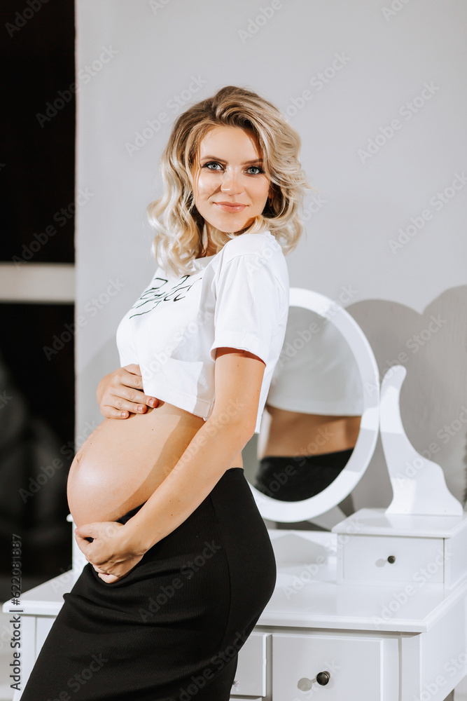 stylish studio portrait of a beautiful pregnant young woman against a mirror background stylish studio portrait of a beautiful pregnant young woman against a mirror background