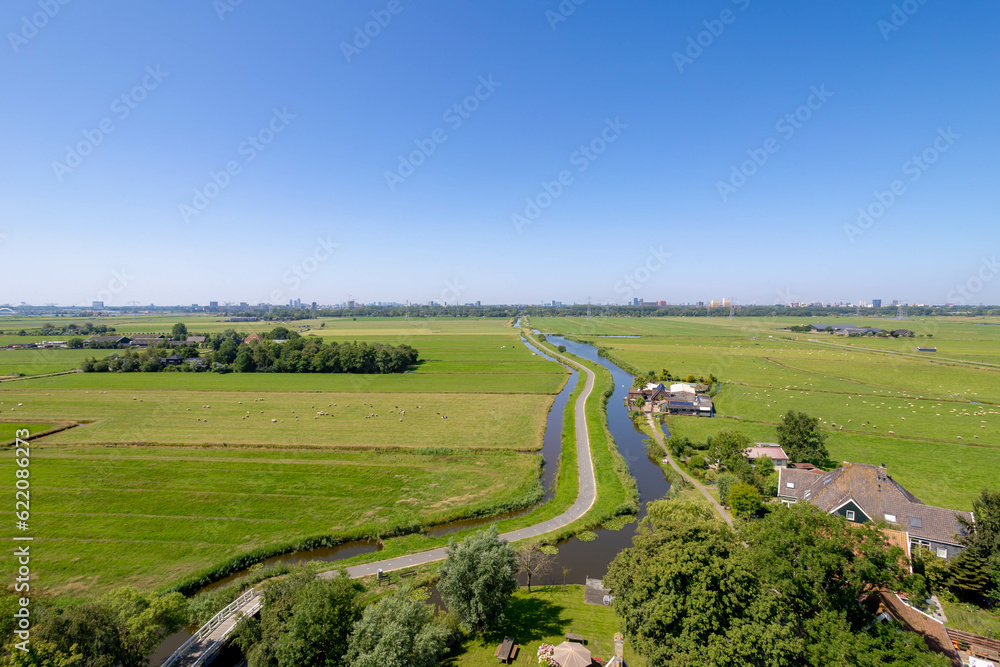 Typical Dutch polder in summer, Canal or ditch and green meadow, Overview from the top of Church tower in Ransdorp, A small village part of the municipality of Amsterdam, North Holland, Netherlands.