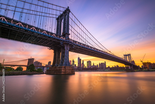New York City at the Manhattan Bridge spanning the East River during sunset.