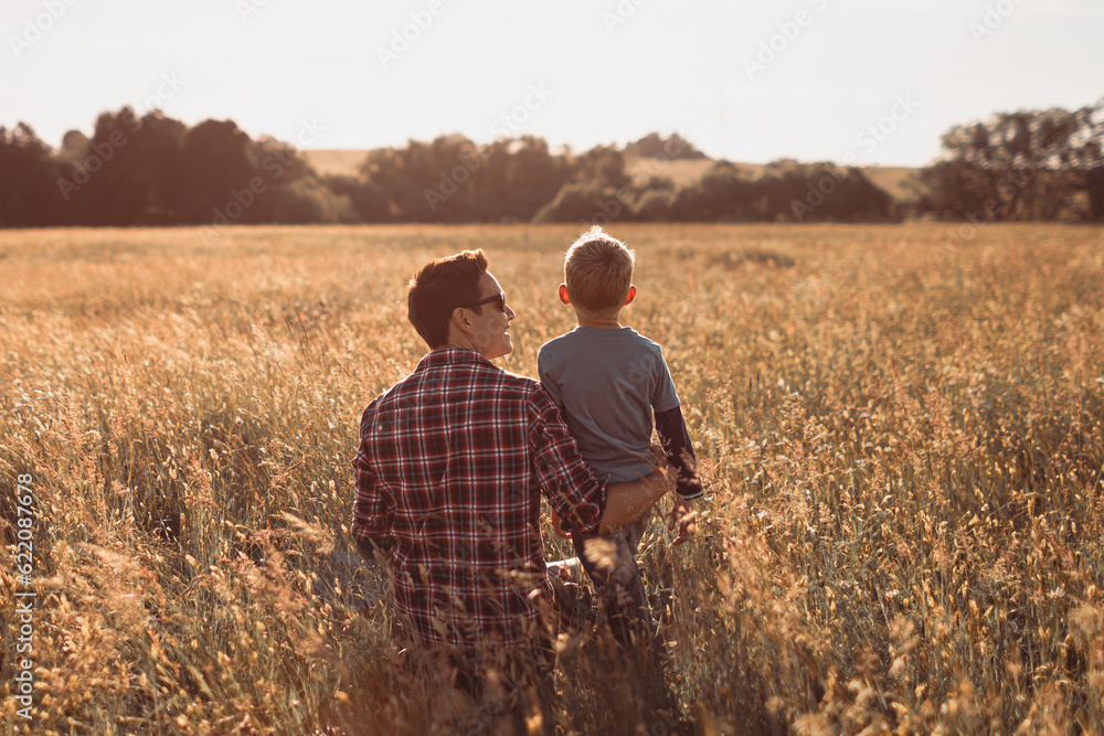 Happy father son moment bonding in nature field celebrating love and togetherness.