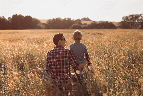 Happy father son moment bonding in nature field celebrating love and togetherness.