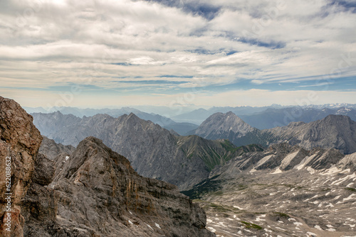 View from mount Zugspitze summit near Garmisch-Partenkirchen, Bavaria, Germany and Tyrol, Austria in summer outdoors. Alpine mountain panorama