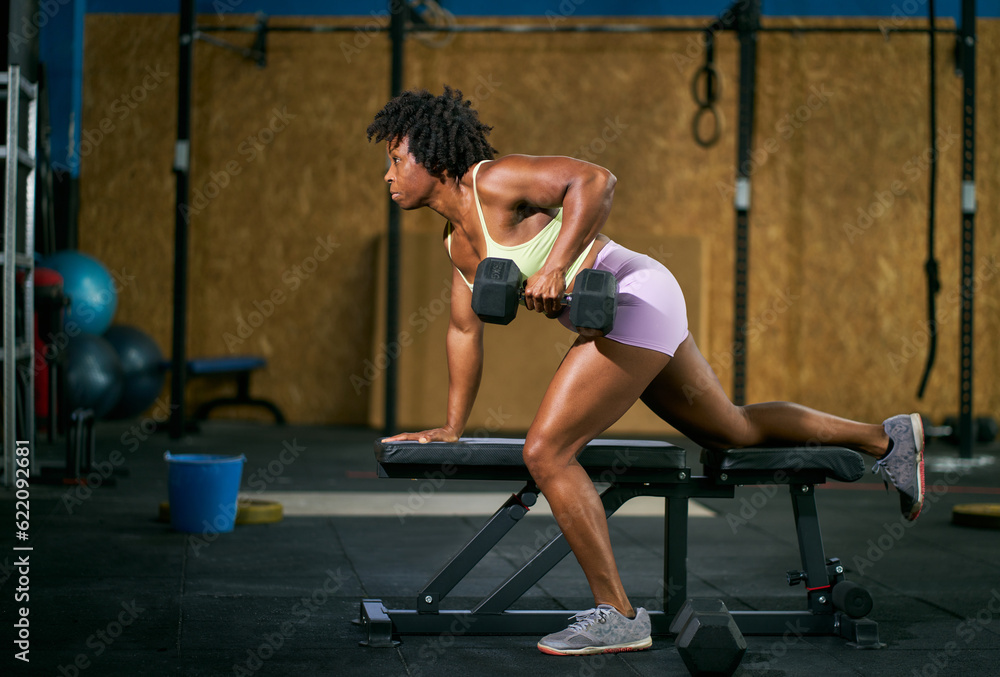 Black athlete exercising on bench with dumbbell Black athlete exercising on bench with dumbbell