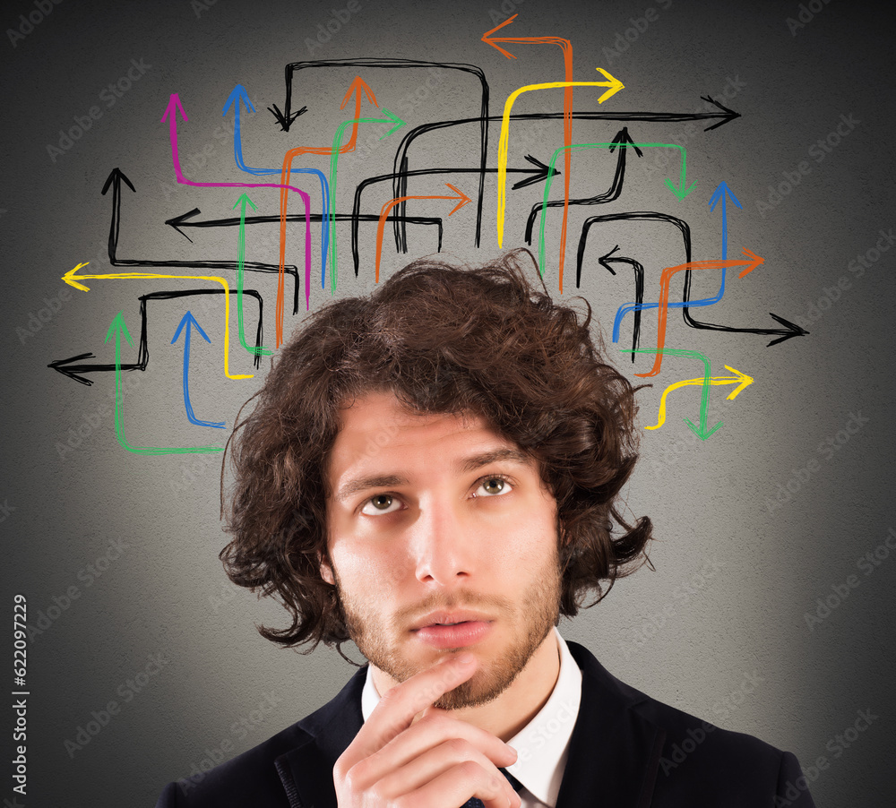 Man with a questioning expression and design of arrows over his head Man with a questioning expression and design of arrows over his head
