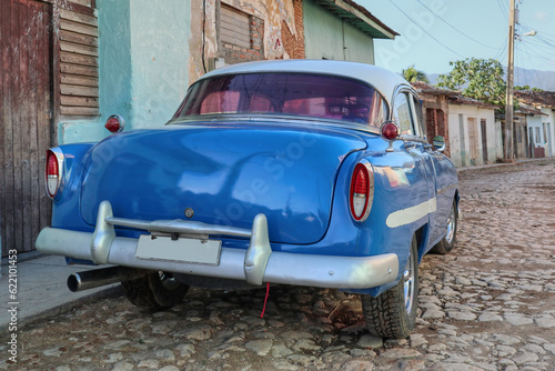 Photography A Cuban retro car using as a Taxi parked on the street of the town of Trinidad