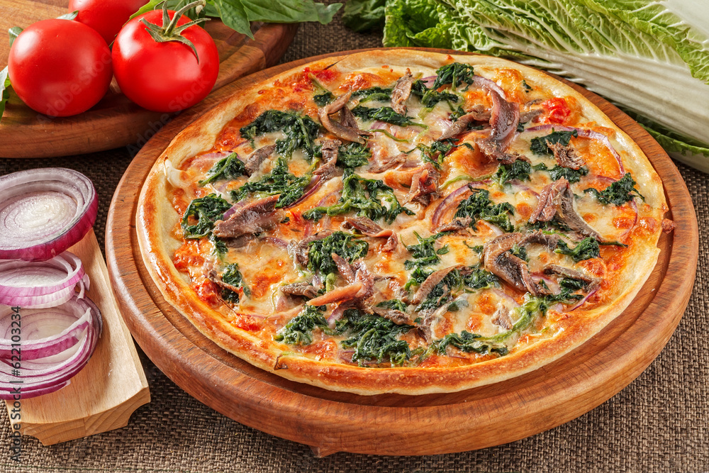 Pizza with anchovies, spinach, tomatoes and cheese Pizza with anchovies, spinach, tomatoes and cheese