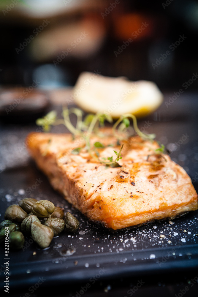 Salmon steak served with pomegranate sauce on a warm plate Salmon steak served with pomegranate sauce on a warm plate