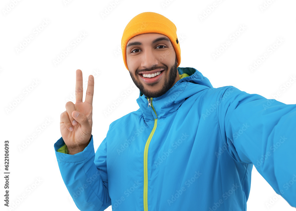 Smiling young man taking selfie and showing peace sign on white background Smiling young man taking selfie and showing peace sign on white background