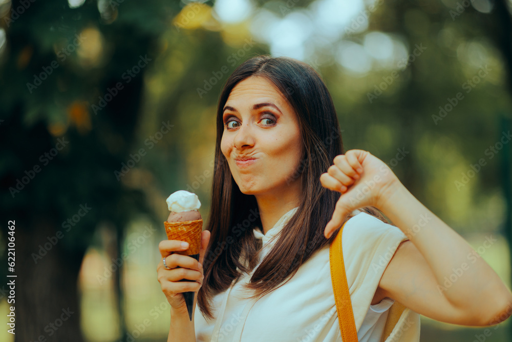 Woman Having an Ice Cream Feeling Disappointed with Taste. Unhappy lady tasting a bad dessert from street food shop
Woman Having an Ice Cream Feeling Disappointed with Taste. Unhappy lady tasting a bad dessert from street food shop