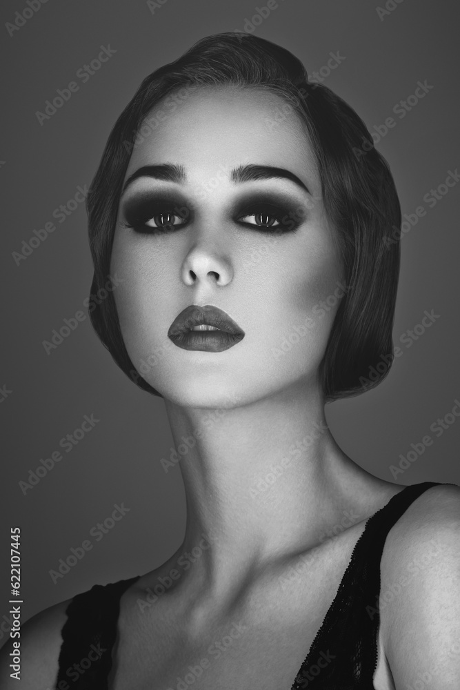 Beautiful young woman with smoky eyes and full red lips. Studio beauty shot. Copy space. Monochrome. Retro styling. Beautiful young woman with smoky eyes and full red lips. Studio beauty shot. Copy space. Monochrome. Retro styling.