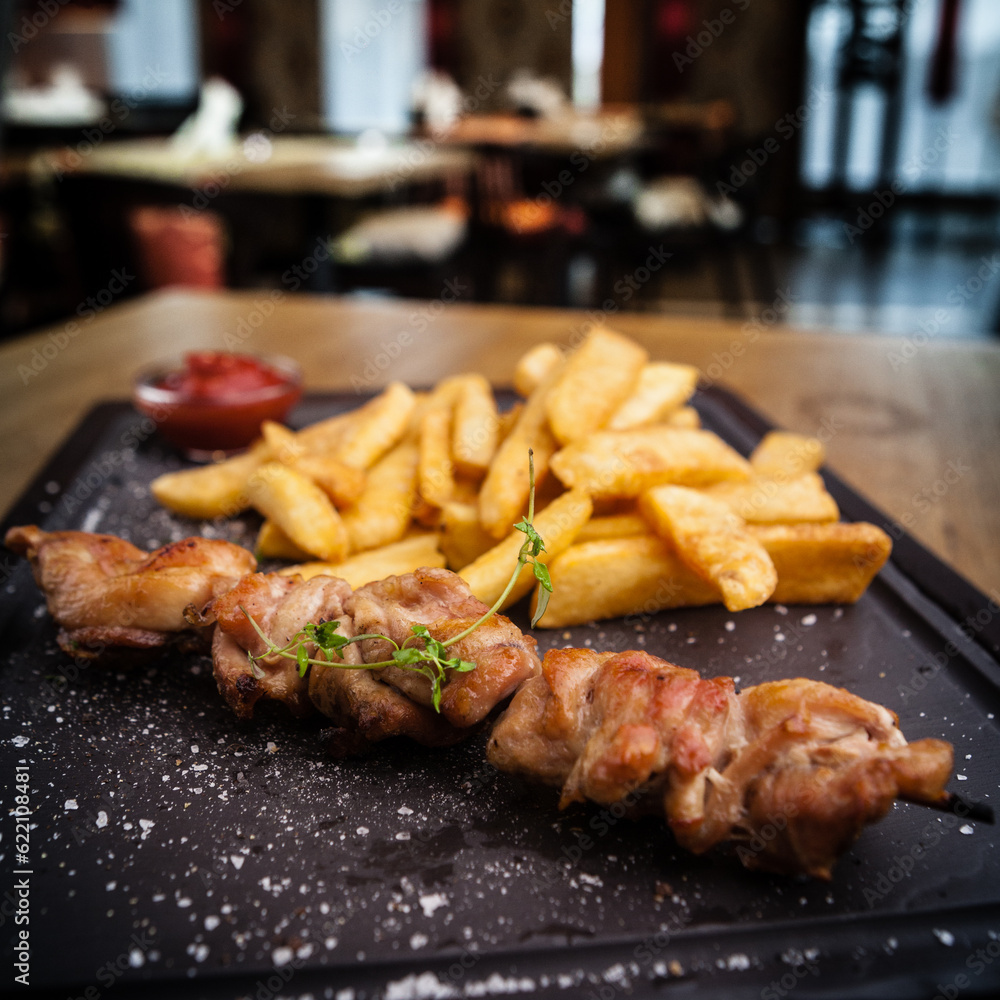 Barbecue grilled pork shashlik kebabs served with french fries Barbecue grilled pork shashlik kebabs served with french fries