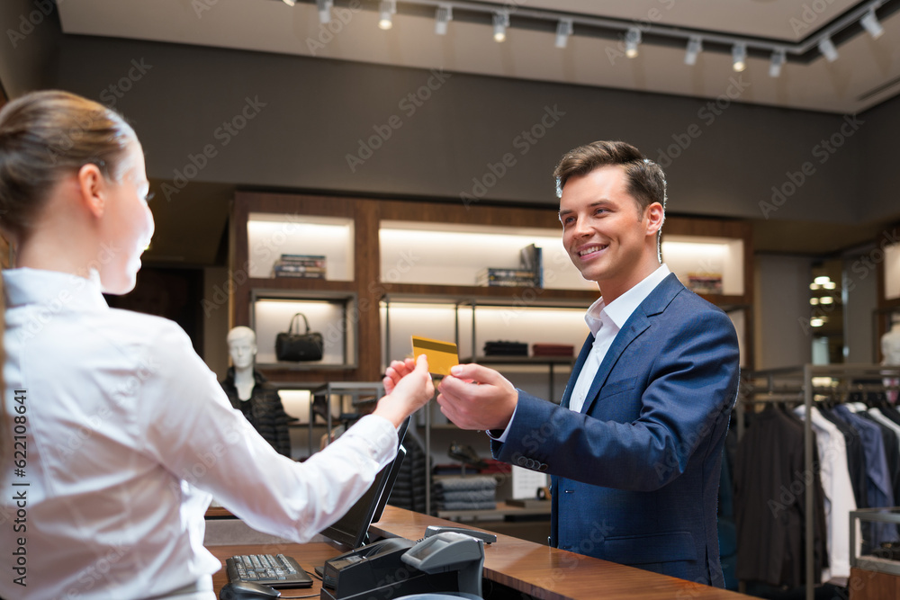 Smiling businessman at counter Smiling businessman at counter