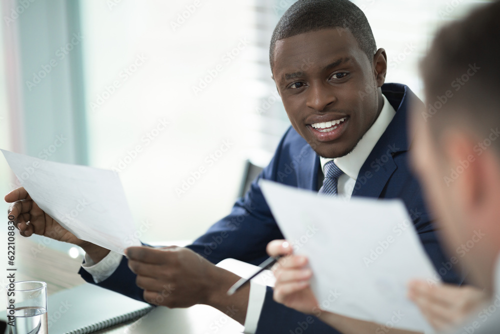 Smiling man in a suit in office