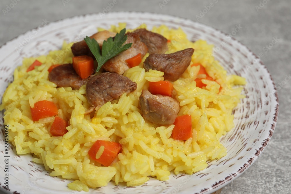 Delicious pilaf with meat served on light grey table, closeup Delicious pilaf with meat served on light grey table, closeup