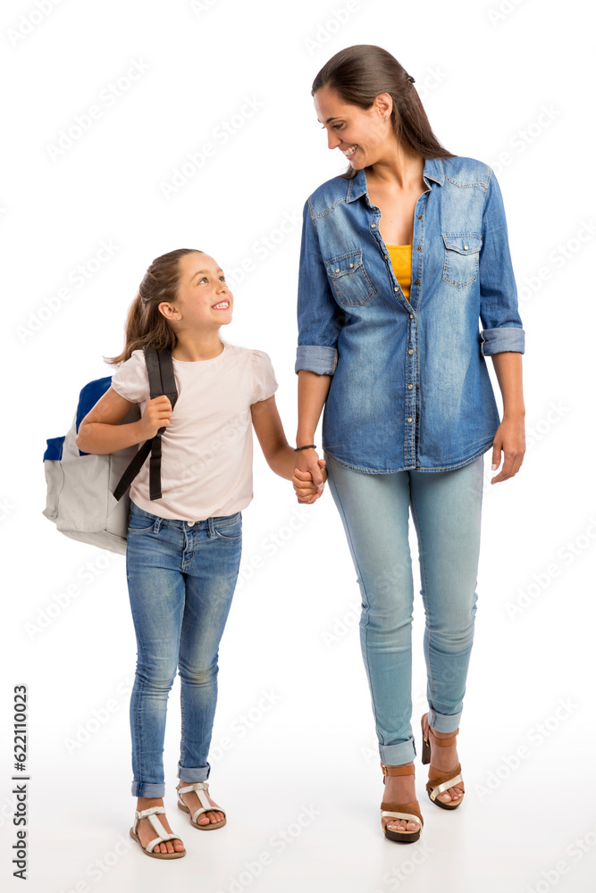 Mother and her little daughter walking together going to the school Mother and her little daughter walking together going to the school