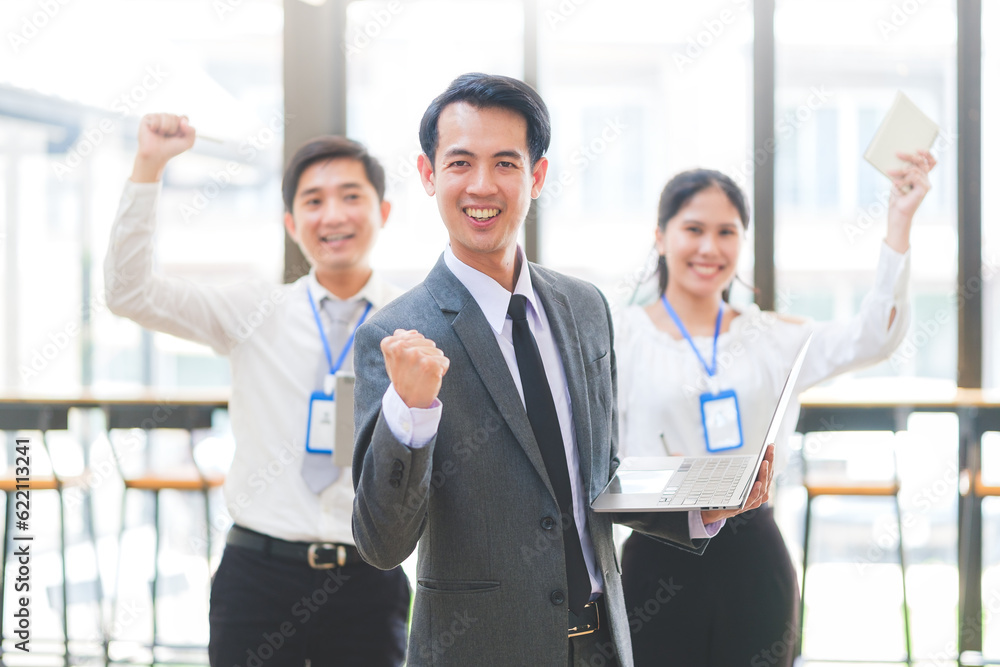 Excited young businesspeople celebrating start up business victory or success in office. Teamwork, collaboration concept. Excited young businesspeople celebrating start up business victory or success in office. Teamwork, collaboration concept.