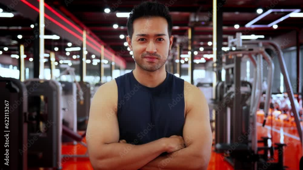 Energetic Fitness Sportsman at Gym. Asian Man Athlete Crosses Arms. Handsome Guy Smart and Confidence in Fitness Center Energetic Fitness Sportsman at Gym. Asian Man Athlete Crosses Arms. Handsome Guy Smart and Confidence in Fitness Center