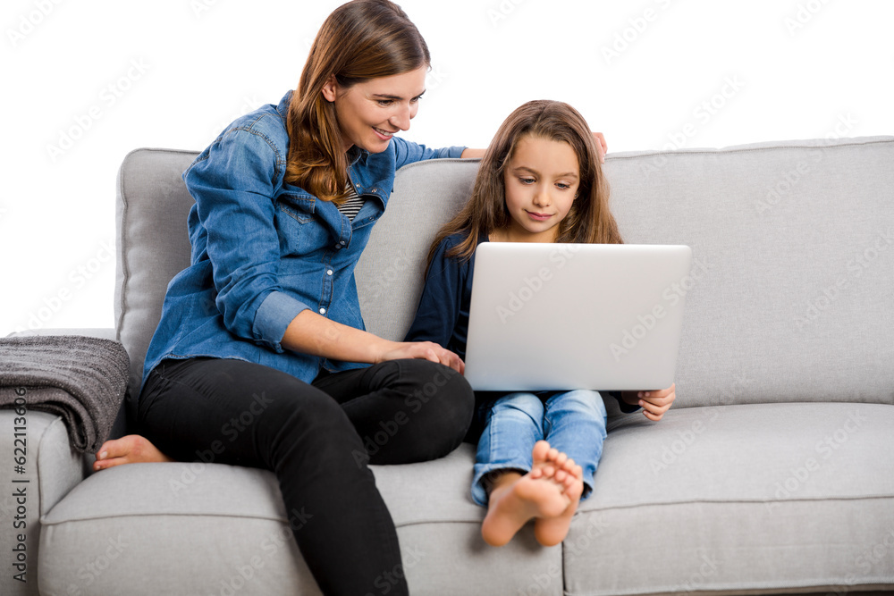 Mother teaching her little daughter working with a laptop Mother teaching her little daughter working with a laptop