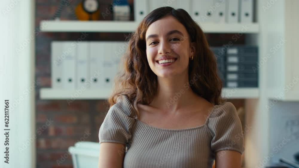 Portrait of young smiling businesswoman working in modern office - shot in slow motion Portrait of young smiling businesswoman working in modern office - shot in slow motion