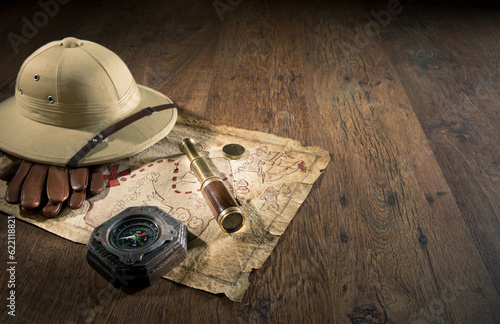 Old treasure map with colonial style pith hat, bras telescope and compass. photo