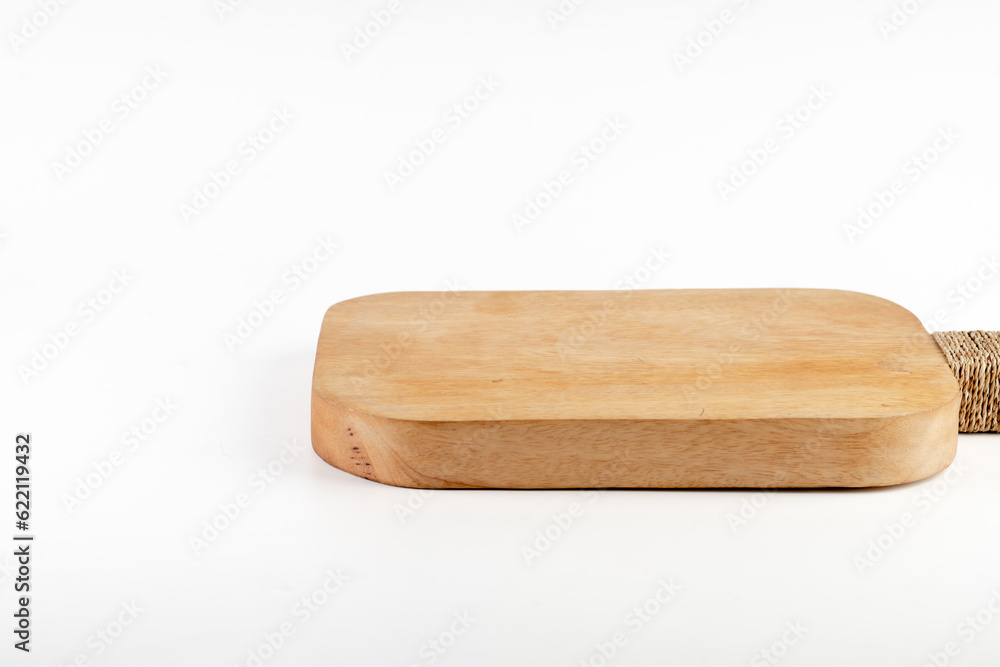 Food preparation tool and kitchen utensils concept with close-up on rectangular wood chopping board with round corners isolated on white background.