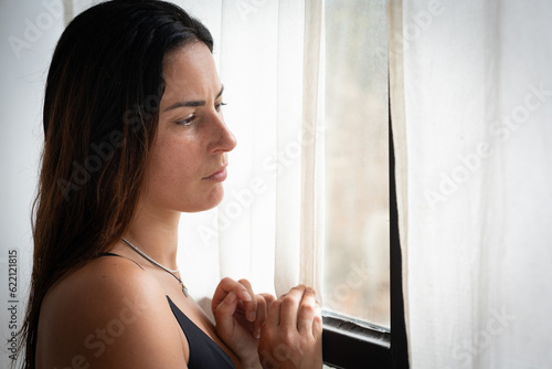 sad, pensive woman looking through window in underwear Free Download sad, pensive woman looking through window in underwear - GFXLoad