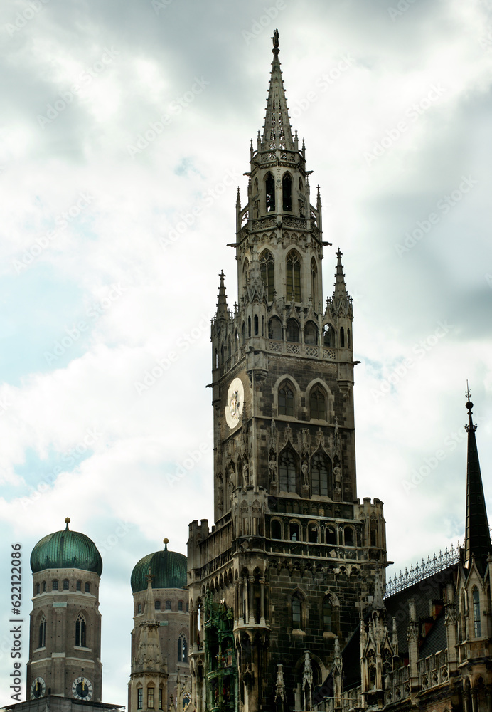 Clock Tower MarienPlatz and Two Towers of Frauenkirche against Cloudy Sky Outdoors. Munich, Germany