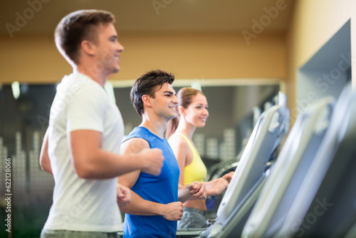 Young sportsman at treadmill indoors