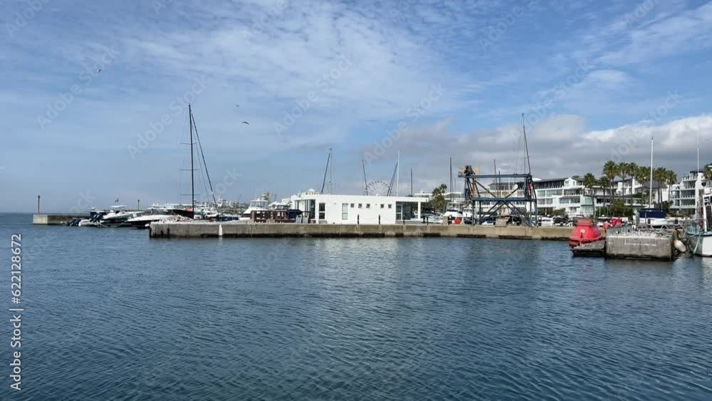 Waterfront marina with yachts and boats by the jetty with ocean view apartments Waterfront marina with yachts and boats by the jetty with ocean view apartments