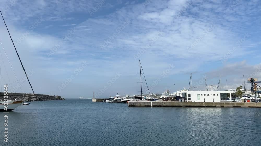 Marina with yachts and catamaran tied up on the pier Marina with yachts and catamaran tied up on the pier