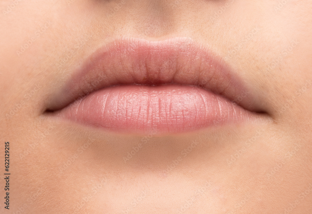 Beautiful young woman's full lips close-up, perfect skincare concept Beautiful young woman's full lips close-up, perfect skincare concept