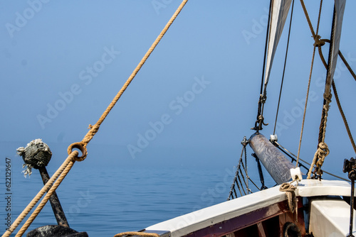 bowsprit of a schooner headed into fog