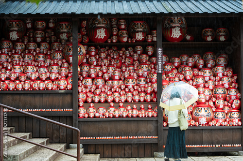 Fotografie A vibrant image showcasing a crowd of Darumas in the streets of Osaka, Japan