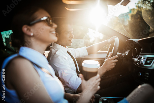 Young businessman and businesswoman driving a car and commuting to work photo