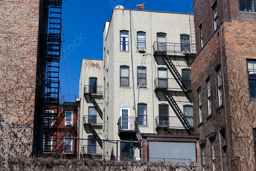 Old Residential Brick Apartment Buildings with Fire Escapes in Nolita of New York City photo